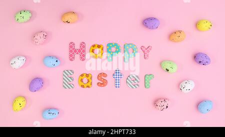 Happy Easter background with colorful eggs and text on pastel pink theme. Creative holidays greeting card Stock Photo