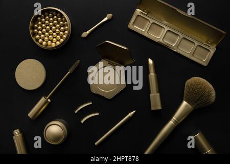 luxury cosmetics - set with golden decorative makeup products on black background. top view Stock Photo