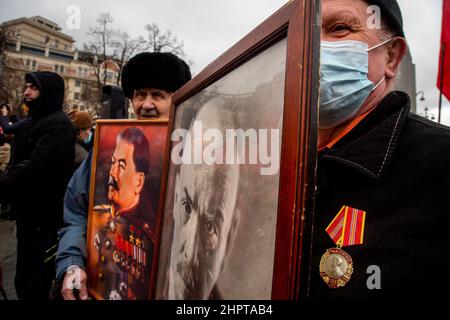 Moscow, Russia. 23rd of February, 2022 People take part in a rally held by the Russian Communist Party on Revolution square near the monument to Karl Marx on Defender of the Fatherland Day in the center of Moscow city, Russia Stock Photo