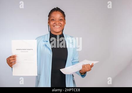 Beautiful African travel agent holding a travel visa application form Stock Photo