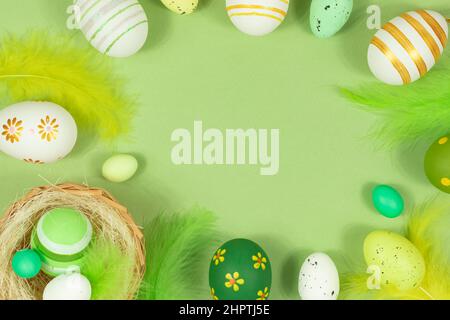 Happy easter. Delicate, pastel salad background with a nest, colorful eggs and feathers. View from above. Place for text. Stock Photo