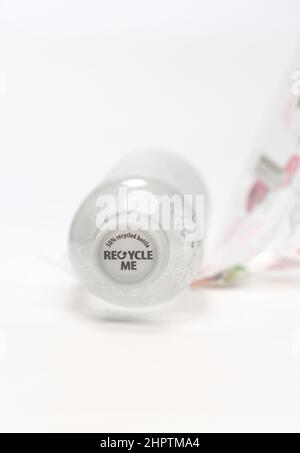 A single use bottle showing cap that has recycle me printed on to it and 50% recycled bottle photographed on a white background. Stock Photo