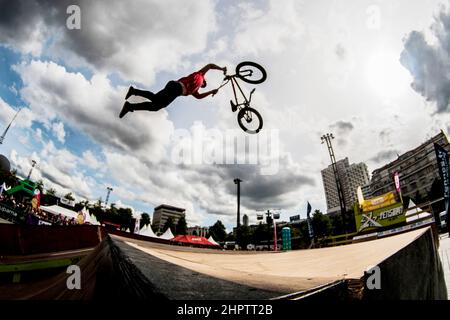 Cyclist stunt riding, often referred to as stunting, is a bicycle sport characterized by stunts involving acrobatic maneuvering of the sports bicycle and sometimes the rider. Common maneuvers in stunt riding include wheelies, stoppies, and burnouts. France. Stock Photo