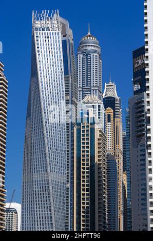Dec 05 2021 - Dubai, UAE: View of Dubai Marina skyscrapers shot from below in portrait mode with clear blue sky.