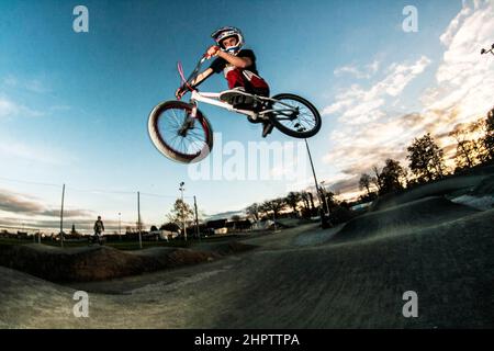 Cyclist stunt riding, often referred to as stunting, is a bicycle sport characterized by stunts involving acrobatic maneuvering of the sports bicycle and sometimes the rider. Common maneuvers in stunt riding include wheelies, stoppies, and burnouts. France. Stock Photo