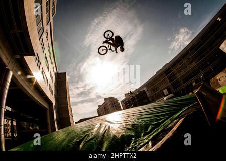 Cyclist stunt riding, often referred to as stunting, is a bicycle sport characterized by stunts involving acrobatic maneuvering of the sports bicycle and sometimes the rider. Common maneuvers in stunt riding include wheelies, stoppies, and burnouts. France. Stock Photo