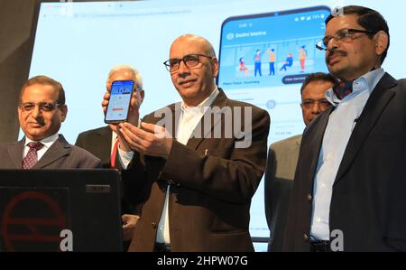 New Delhi, India. 23rd Feb, 2022. Delhi Metro Rail Corporation (DMRC), Managing Director, Mangu Singh (2nd Left) holds a mobile phone during the launch of the revamped official website and Mobile application at Metro Bhawan.The new Website and Mobile application are loaded with many new advanced features such as interactive route maps, advanced station search options, real time first and last train time calculator, next and nearest station alert on the app etc. Credit: SOPA Images Limited/Alamy Live News Stock Photo