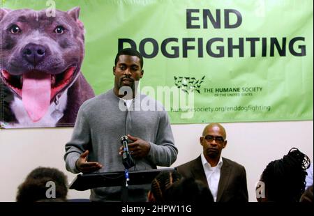 Durham, USA. 26th Feb, 2010. Philadelphia Eagles quarterback Michael Vick makes a stop in Durham, North Carolina, Friday, Feb. 26, 2010, to speak to students and local residents at the New Horizons alternative school about his mistakes being involved in dog fighting and of second chances in life. He was introduced to the packed assembly room by Ralph Hawthorne, right, of the Humane Society of the United States. (Photo by Harry Lynch/The News & Observer/TNS/Sipa USA) Credit: Sipa USA/Alamy Live News Stock Photo