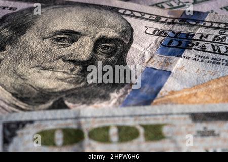 Closeup on Benjamin Franklin portrait on a one hundred US American paper banknote currency. Money for exchange. Global recession and inflation rate Stock Photo