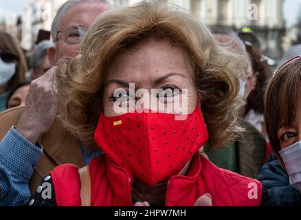 Madrid, Spain. 23rd Feb, 2022. A woman wearing a red face mask with the Spanish flag seen during a tribute to the deceased sailors of the 'Villa de Pitanxo' boat that sank in the north-east coast of Canada as the president of the Community of Madrid, Isabel Diaz Ayuso, attends a minute of silence at the Real Casa de Correos in Madrid. Credit: SOPA Images Limited/Alamy Live News