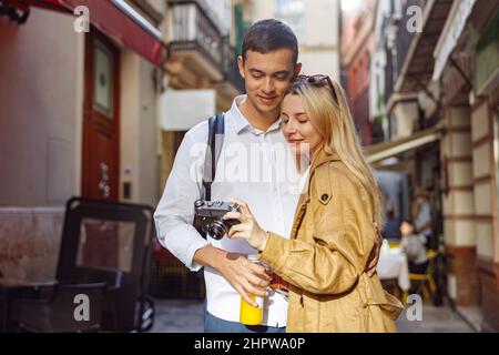 Charming couple looking at the camera standing on street Stock Photo