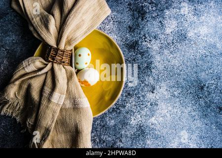 Easter minimalistic place setting on concrete background Stock Photo