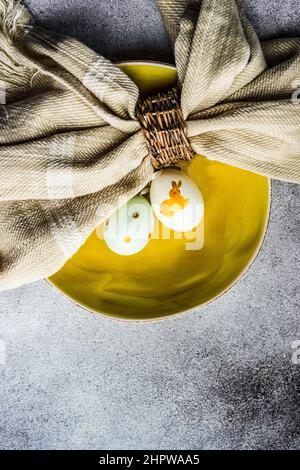 Easter minimalistic place setting on concrete background Stock Photo