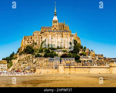 Le Mont Saint Michel, stunning view of the famous abbey during low tide on a bright sunny day, Normandy, Northern France