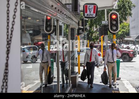 Cape Town, South Africa. 23rd Feb, 2022. People walk past a restaurant in Cape Town, South Africa, on Feb. 23, 2022. South Africa's Minister of Finance Enoch Godongwana on Wednesday predicted an improved fiscal outlook in his budget speech for 2022/23 financial year, while saying it is subjected to 'significant' risks. Credit: Lyu Tianran/Xinhua/Alamy Live News Stock Photo