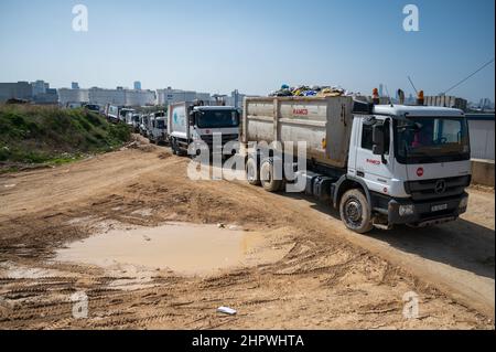 Beirut, Lebanon. 18th Feb, 2022. Garbage trucks of the Lebanese waste company Ramco stand in front of the entrance of a landfill in Beirut. In the midst of the worst economic crisis in Lebanon, the waste management industry is threatened with a new low.(to dpa: 'Economic crisis in Lebanon - the poorest struggle for garbage') Credit: Arne Bänsch/dpa/Alamy Live News Stock Photo