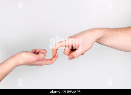 Fingers of Two People Nearly Touching - Isolated Stock Photo