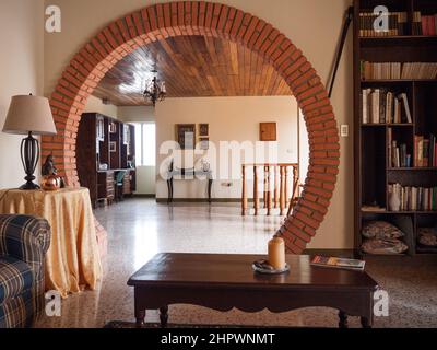 Interior of an Art Deco building with a moon arch framed in brick, in Jinotega, Nicaragua.  This building was reopened as a hotel for a few years. Stock Photo