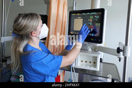 Rostock, Germany. 23rd Feb, 2022. In the cardiology watch unit at Klinikum Südstadt Rostock, Jenny-Lee Hocher, a nurse, prepares medical monitoring for a patient. At the presentation of the Barmer Nursing Report on February 24, 2022 in Schwerin, information will be provided on what specific developments can be expected in nursing care up to 2030. New projections show that significantly more people in need of care will have to be cared for in the state than previously assumed. This will also increase the need for nursing staff. Credit: Bernd Wüstneck/dpa-Zentralbild/dpa/Alamy Live News Stock Photo