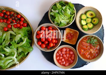 Vietnamese healthy food with vegan ingredient in green, red, salad mix with tomato sauce, strawberry, avocado, nutrition eating for detox, diet menu i Stock Photo