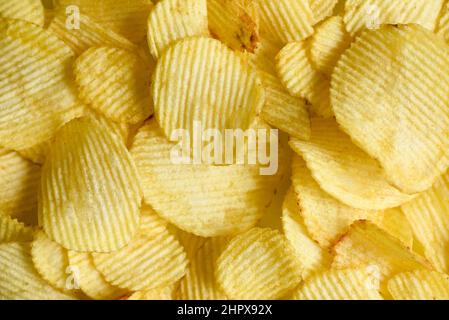 Potato chips texture background, Corrugated crispy potato chips snack - top view Stock Photo