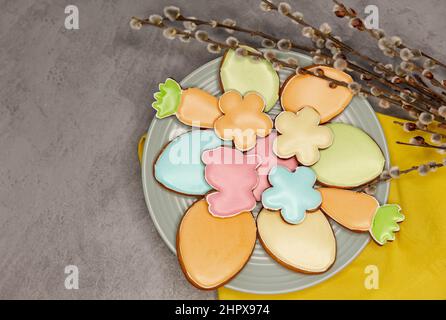 Homemade easter cookies in shape of a funny rabbit, eggs, on plate. Stock Photo