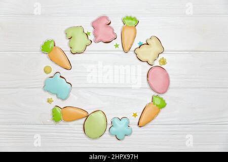 Multicoloured cookies shaped as rabbits, carrots, eggs and flowers. Stock Photo