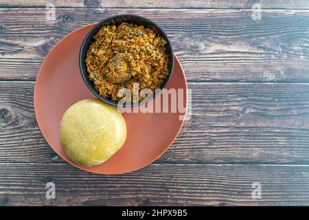 Nigerian Eba or Garrie Served with Egusi Soup for lunch Stock Photo