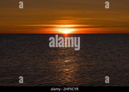 Dazzling sun over the sea Stock Photo