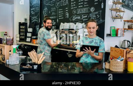 Smiling coffee shop workers posing Stock Photo
