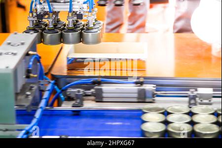 Production line of automation robot handling food can to conveyor in food industry Stock Photo
