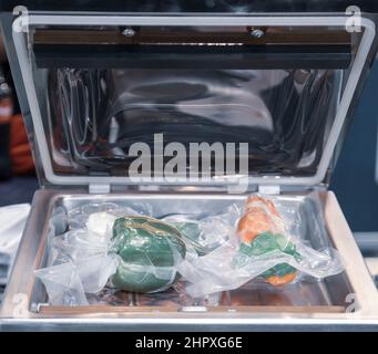 Vacuum heat sealing machine for food package Stock Photo - Alamy