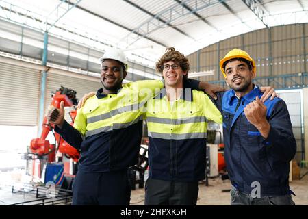 engineer checking control panel and teaching new Automatics robot arm and operating control machine in factory. Stock Photo