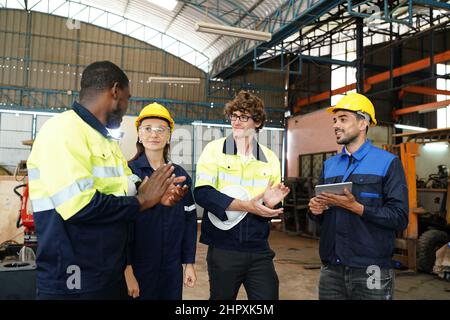 engineer checking control panel and teaching new Automatics robot arm and operating control machine in factory. Stock Photo