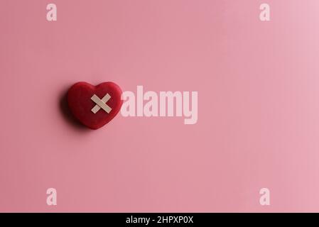Healthcare, medical insurance and world heart day concept with red heart and bandage. Copy space. Stock Photo