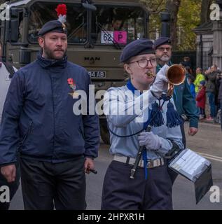 Female blows a bugle while marching with the Corps of Drums Society at the Lord Mayor’s Show 2021, Victoria Embankment, London, England, UK. Stock Photo