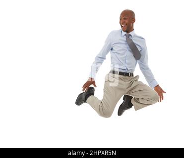 Hes on top of the world. An African-American businessman jumping in the air. Stock Photo