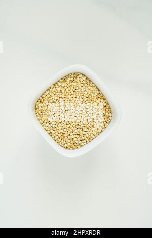 Bowl of white chia seeds on white marble background Stock Photo