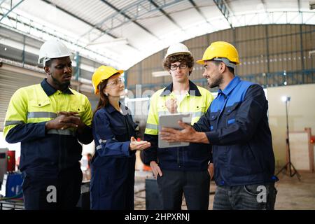 engineer checking control panel and teaching new Automatics robot arm and operating control machine in factory. Stock Photo