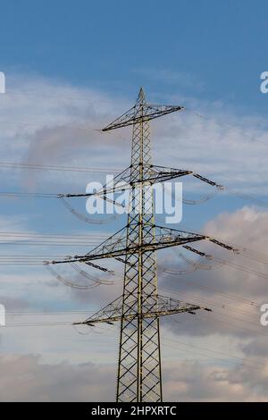 view of electric pylon under clear blue sky Stock Photo - Alamy