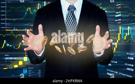 Bitcoins falling in to Businessmans hands. Cryptocurrency and banking concept Stock Photo