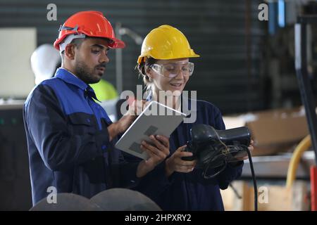 Factory Engineer Operating machines in industry factory. Stock Photo