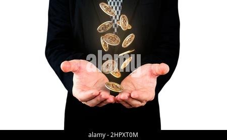 Bitcoins falling in to Businessmans hands. Cryptocurrency and banking concept Stock Photo