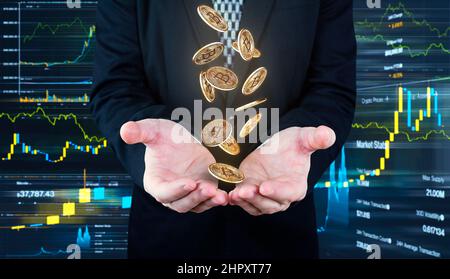 Bitcoins falling in to Businessmans hands. Cryptocurrency and banking concept Stock Photo