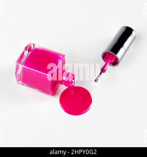 Dont cry over spilt varnish. Studio shot of bottle lying sideways spilling out nail varnish. Stock Photo