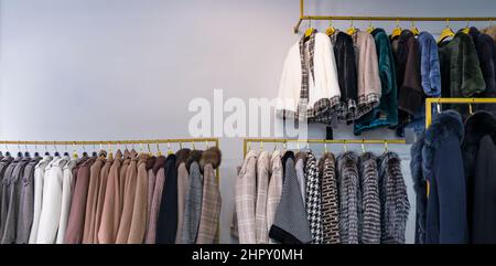 Spring women's coats hanging on a rack in a women's clothing store Stock Photo