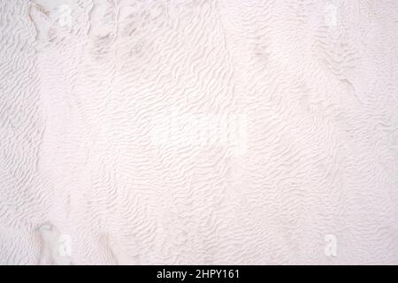 Background of natural white wall Pamukkale calcium travertine in Turkey, asymmetric pattern close-up. Pamukkale. Stock Photo
