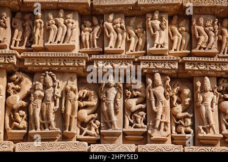 Carved stone figures on the exterior of Parsvanath Temple, a Jain Temple in the eastern group at Khajuraho in Madhya Pradesh, India Stock Photo