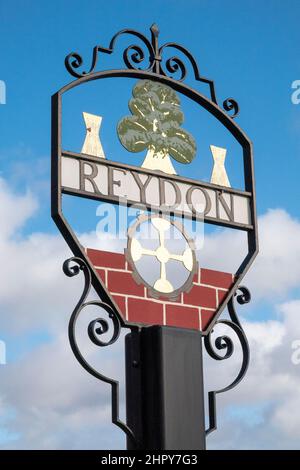 Metal painted and crafted village sign of Reydon in Suffolk designed by Peter Gerrell against a mottled blue sky Stock Photo