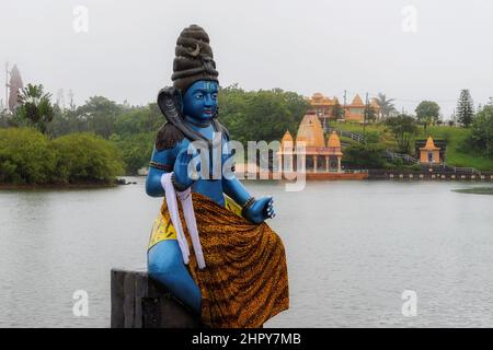 Statue of Shiva in a Hindu temple in Ganga Talao crater lake (Grand Basin), Mauritius Stock Photo